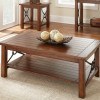 Solid wood rectangular coffee table with rough wood and metal holders will beautify any interior.