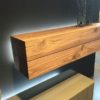 Real wood floating shelves are the most effective and practical way to use the space.
