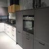 There are dozens of kinds of modern dark grey kitchen cabinets made of wood.