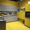 There are dozens of kinds of grey and yellow kitchen cabinets made of wood.