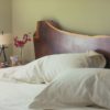 Wood slab headboard is one of the most common pieces placed in the center of bedroom.
