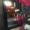 Black Frame Mirror On The Floor With Pink Candelabra